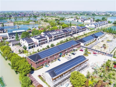                                         		　　图为4月7日无人机拍摄的空中俯瞰德清县新安镇舍北村，许多村民屋顶都安装了光伏发电设备。新华社记者 徐昱摄	　　近几年来，浙江省德清县新安镇大力推进家庭屋顶光伏工程，采用&ldquo;全电上网&rdquo;的模式将村民屋顶光伏所发的清洁电能全部并入当地电网