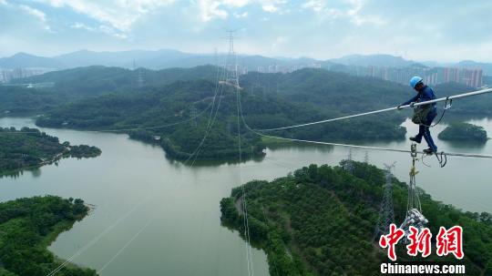 　　電網(wǎng)工人在百米高空進(jìn)行工程安裝作業(yè)?！∩虻椤z　　南方電網(wǎng)廣東東莞縱江變電站配套500千伏線路二期工程6月28日竣工投運(yùn)